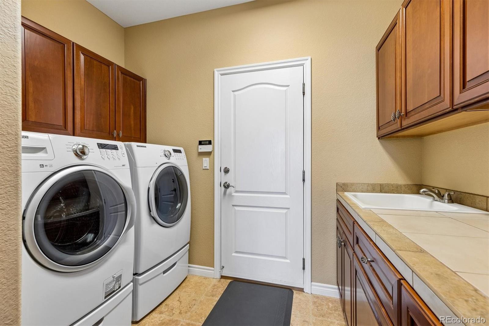 11025 Grayledge Circle Highlands Ranch, CO 80130 - Photo 17 of 46 a utility room with dryer and washer