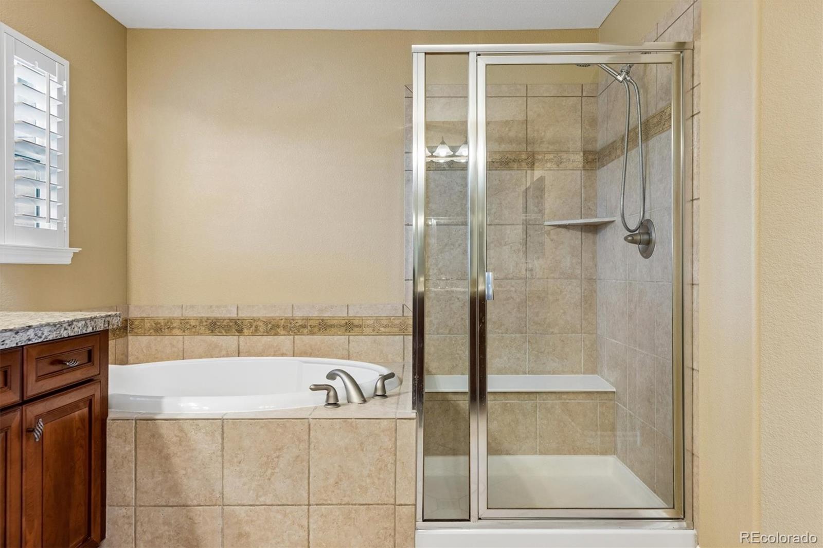11025 Grayledge Circle Highlands Ranch, CO 80130 - Photo 20 of 46 a bathroom with a bathtub and shower