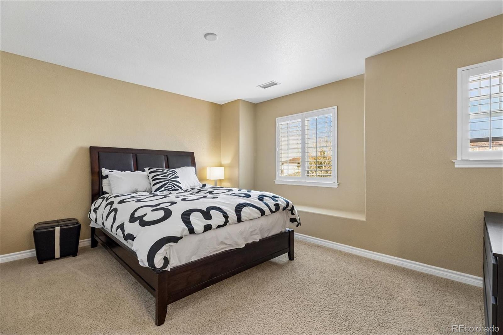 11025 Grayledge Circle Highlands Ranch, CO 80130 - Photo 22 of 46 a bed sitting in a bedroom next to a window