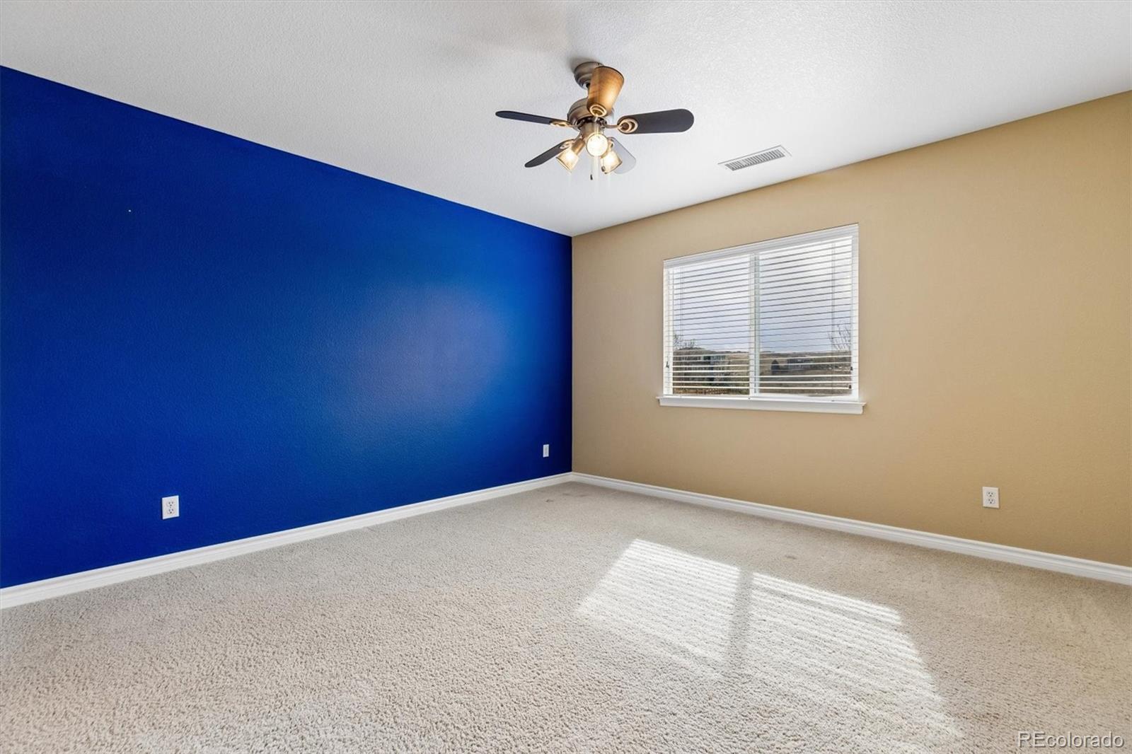 11025 Grayledge Circle Highlands Ranch, CO 80130 - Photo 24 of 46 a view of a livingroom with a ceiling fan and window