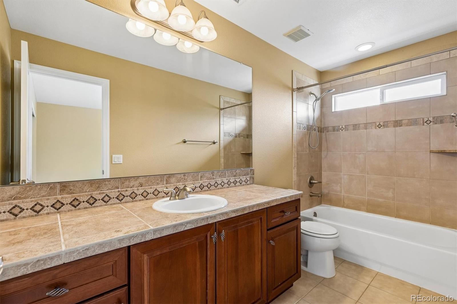 11025 Grayledge Circle Highlands Ranch, CO 80130 - Photo 27 of 46 a bathroom with a sink a toilet and shower