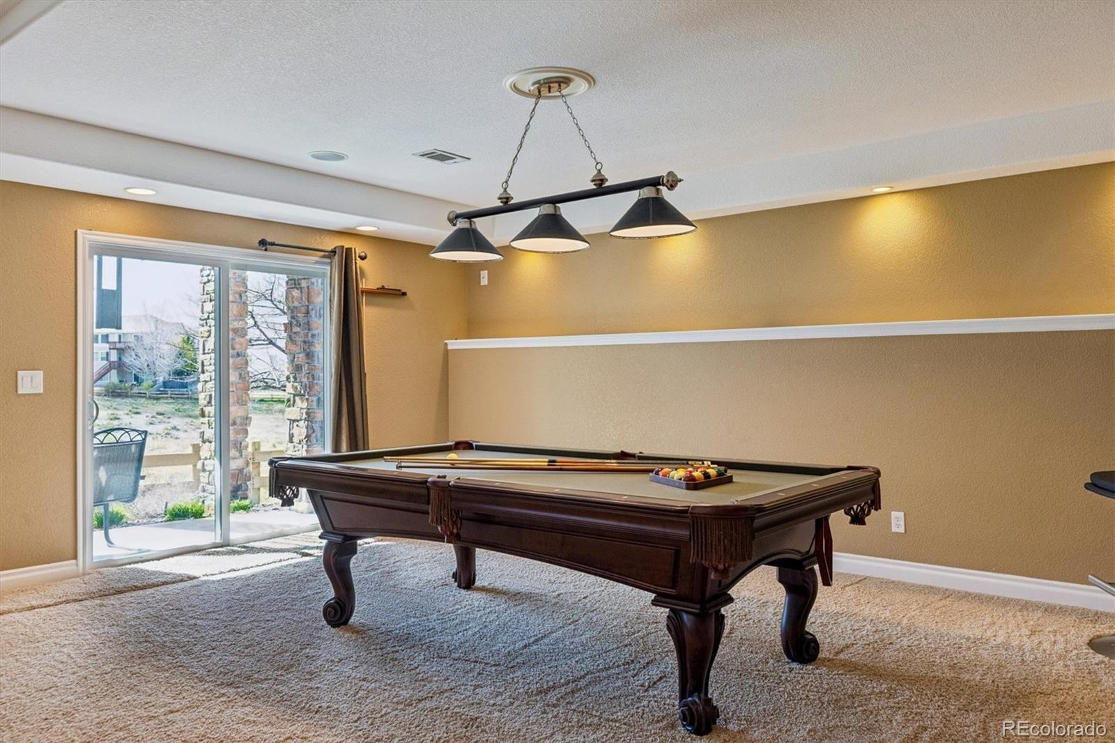 11025 Grayledge Circle Highlands Ranch, CO 80130 - Photo 29 of 46 a room with furniture pool table and windows