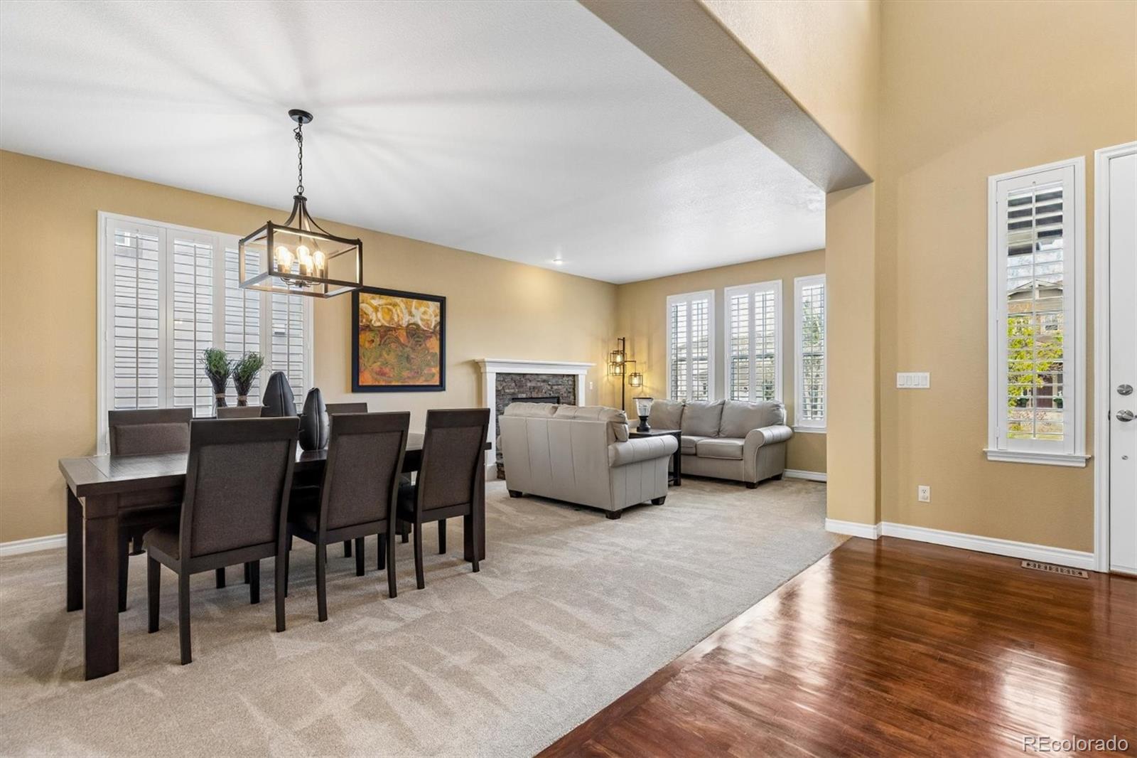 11025 Grayledge Circle Highlands Ranch, CO 80130 - Photo 3 of 46 a living room with furniture a dining table and a window
