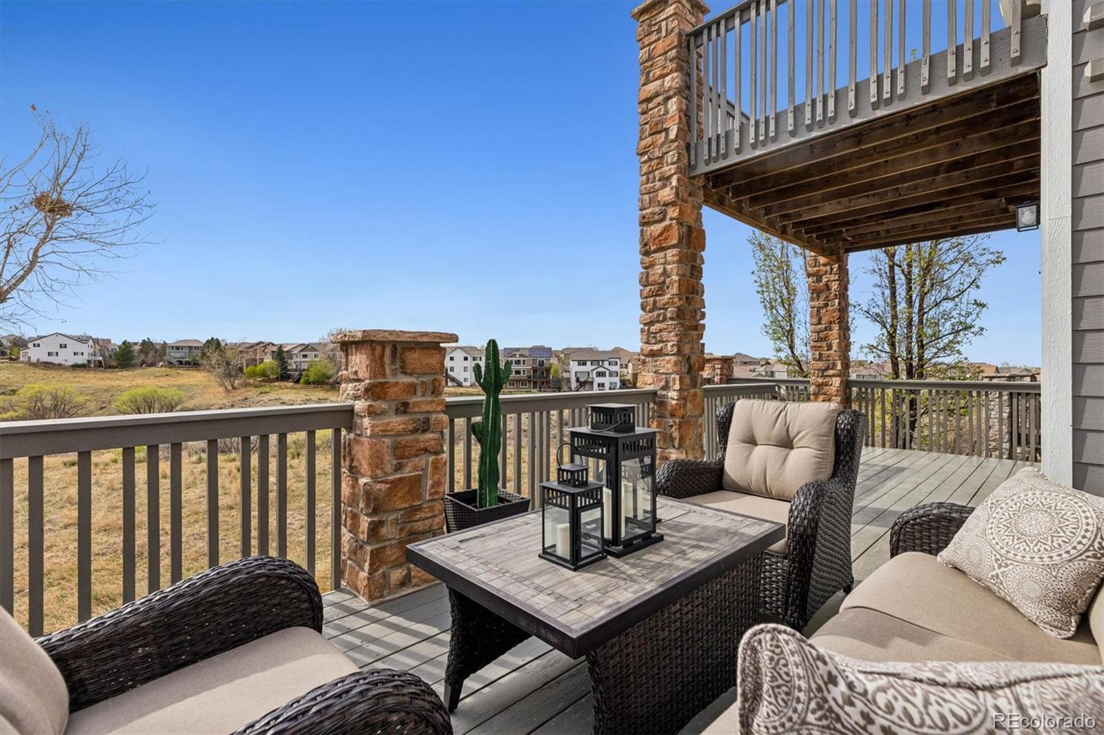 11025 Grayledge Circle Highlands Ranch, CO 80130 - Photo 37 of 46 a view of a balcony with couches and wooden floor