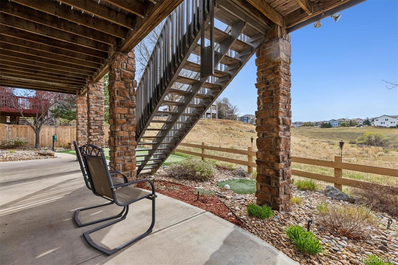 11025 Grayledge Circle Highlands Ranch, CO 80130 - Photo 38 of 46 a view of a porch with wooden floor and fence