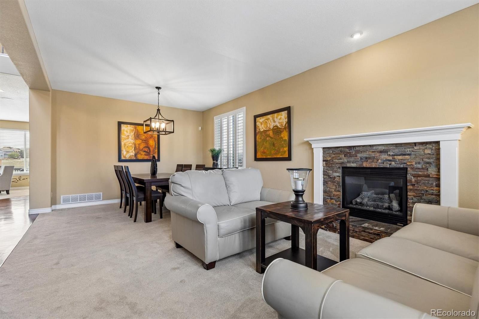 11025 Grayledge Circle Highlands Ranch, CO 80130 - Photo 6 of 46 a living room with furniture and a fireplace