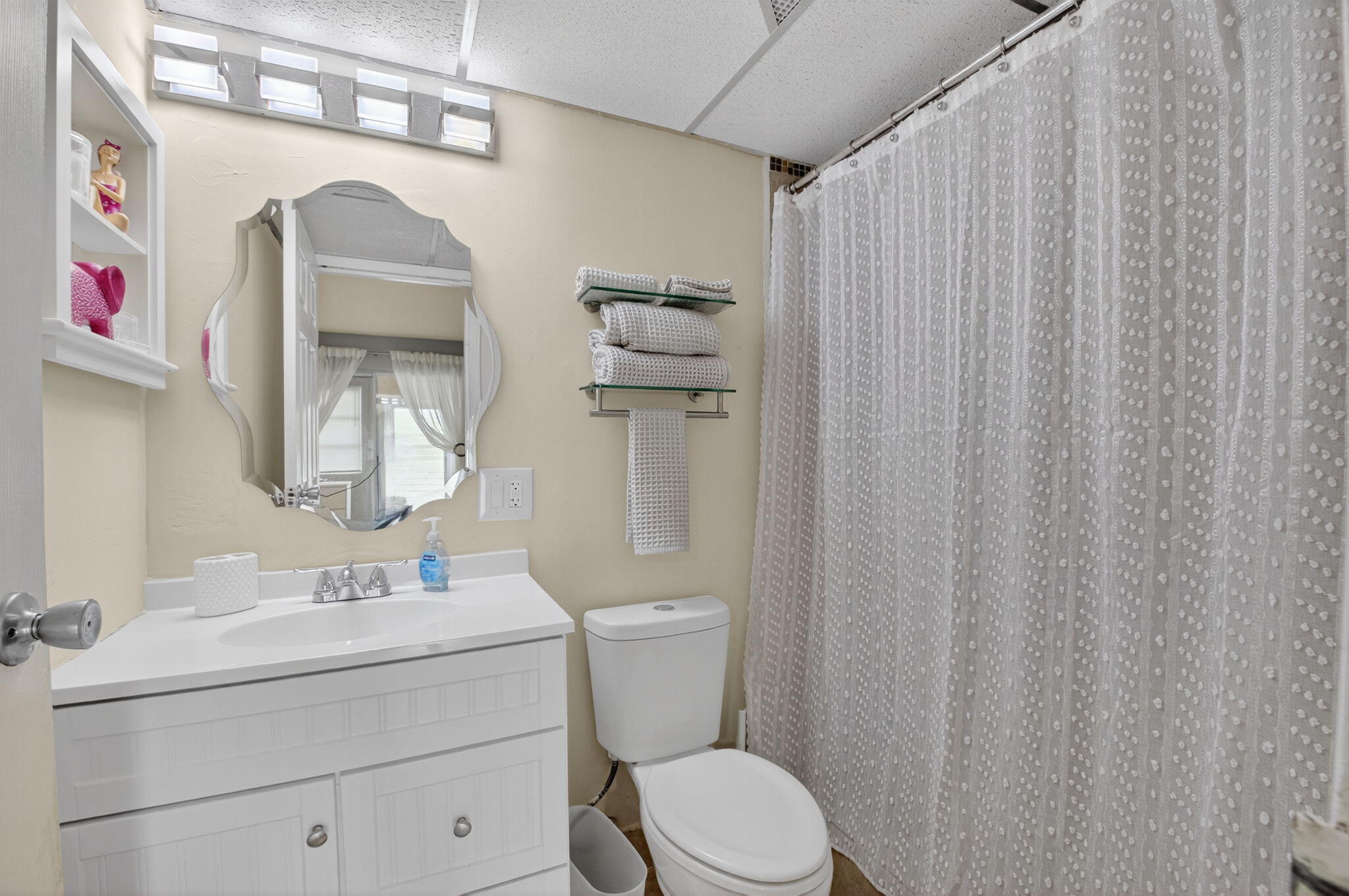 499 Monaco Way, Unit K Delray Beach, FL 33446 - Photo 14 of 33 a bathroom with a sink a toilet and shower curtain