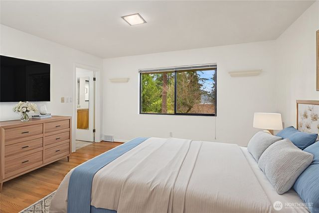 a bedroom with a bed and a flat screen tv in it