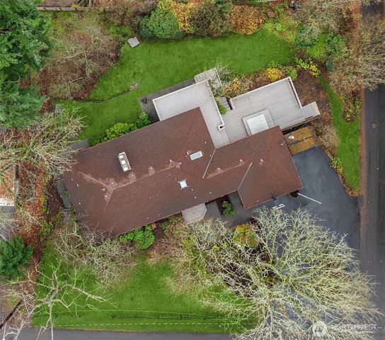 an aerial view of a house with a yard and lake view