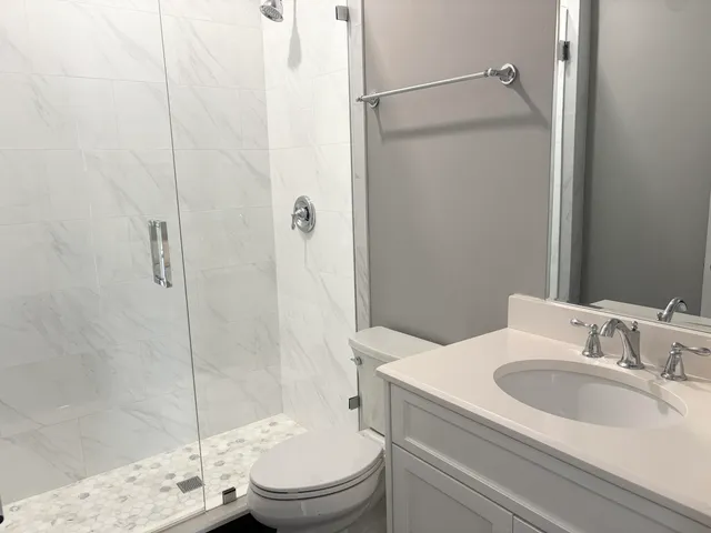a bathroom with a sink toilet and shower