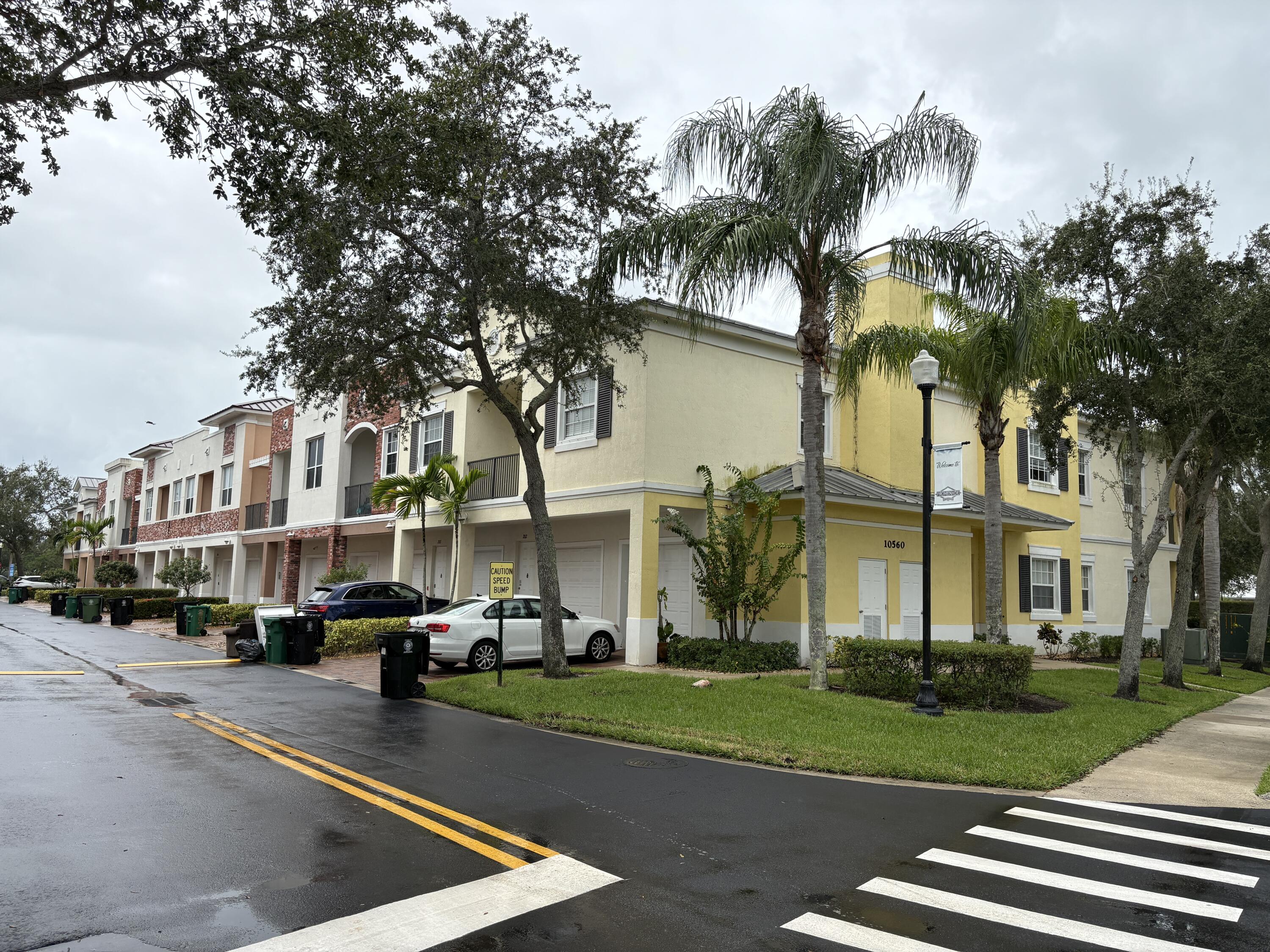 10560 Southwest Stephanie Way, Unit 1202 Port St. Lucie, FL 34987 - Photo 2 of 19 a view of multiple houses with yard and green space