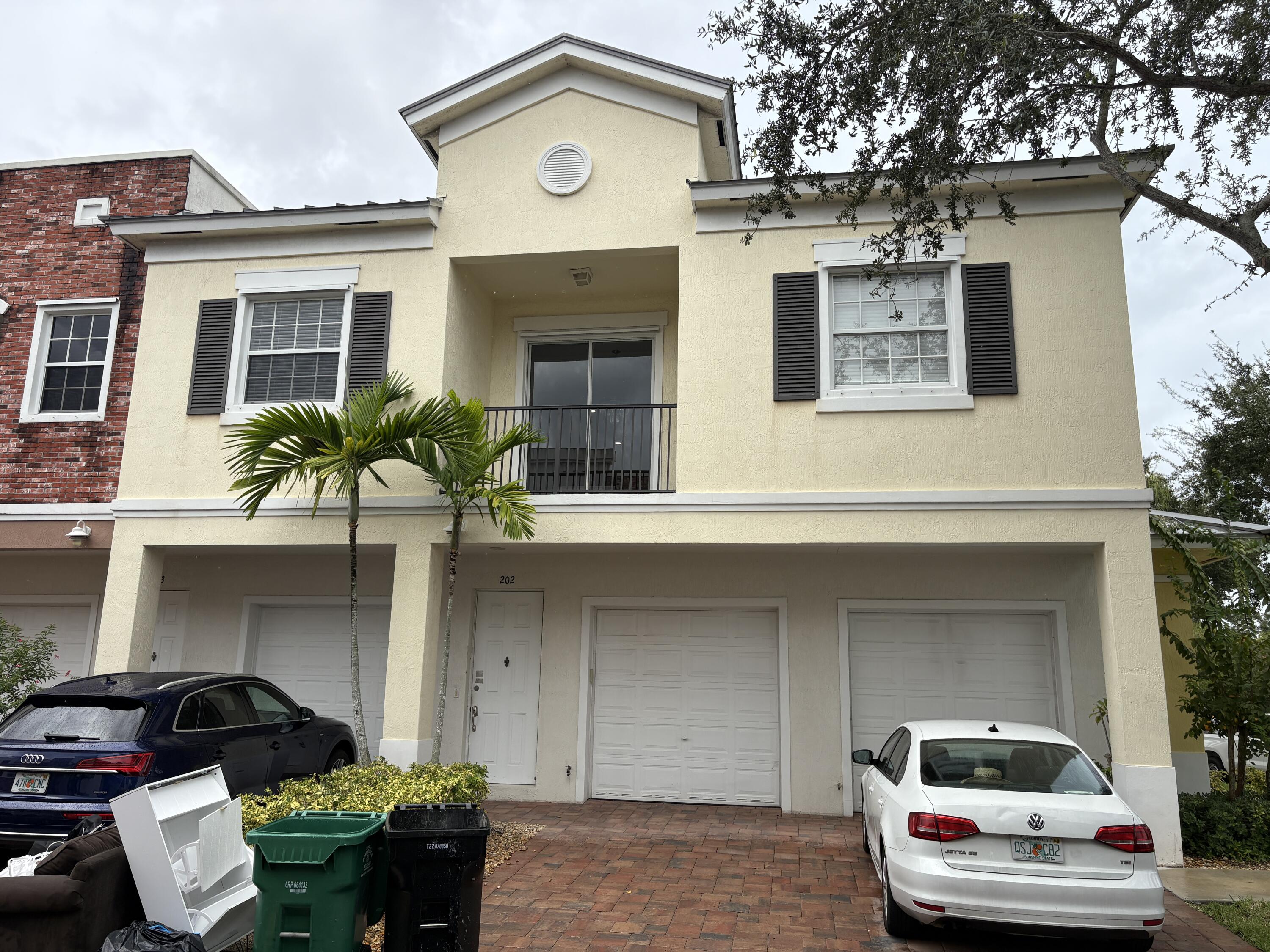 10560 Southwest Stephanie Way, Unit 1202 Port St. Lucie, FL 34987 - Photo 3 of 19 a front view of a house with garden