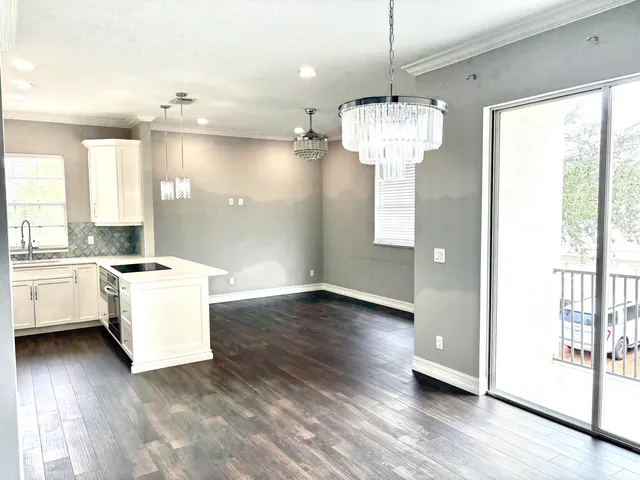 a view of a kitchen with a dishwasher cabinets and a large window
