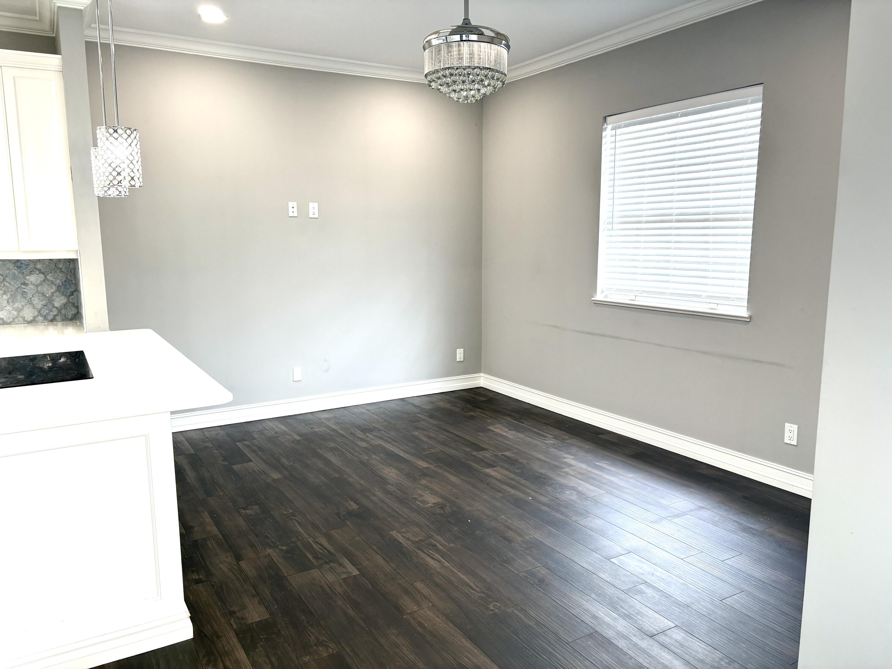 10560 Southwest Stephanie Way, Unit 1202 Port St. Lucie, FL 34987 - Photo 6 of 19 wooden floor in an empty room with a window