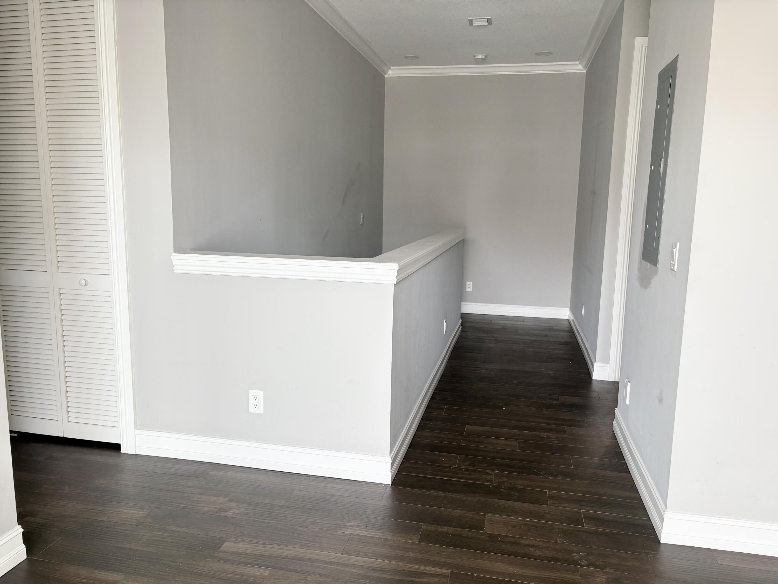 10560 Southwest Stephanie Way, Unit 1202 Port St. Lucie, FL 34987 - Photo 8 of 19 a view of a hallway with wooden floor