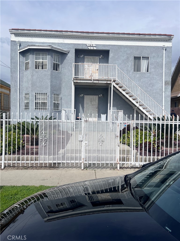 a view of a house with a wooden fence