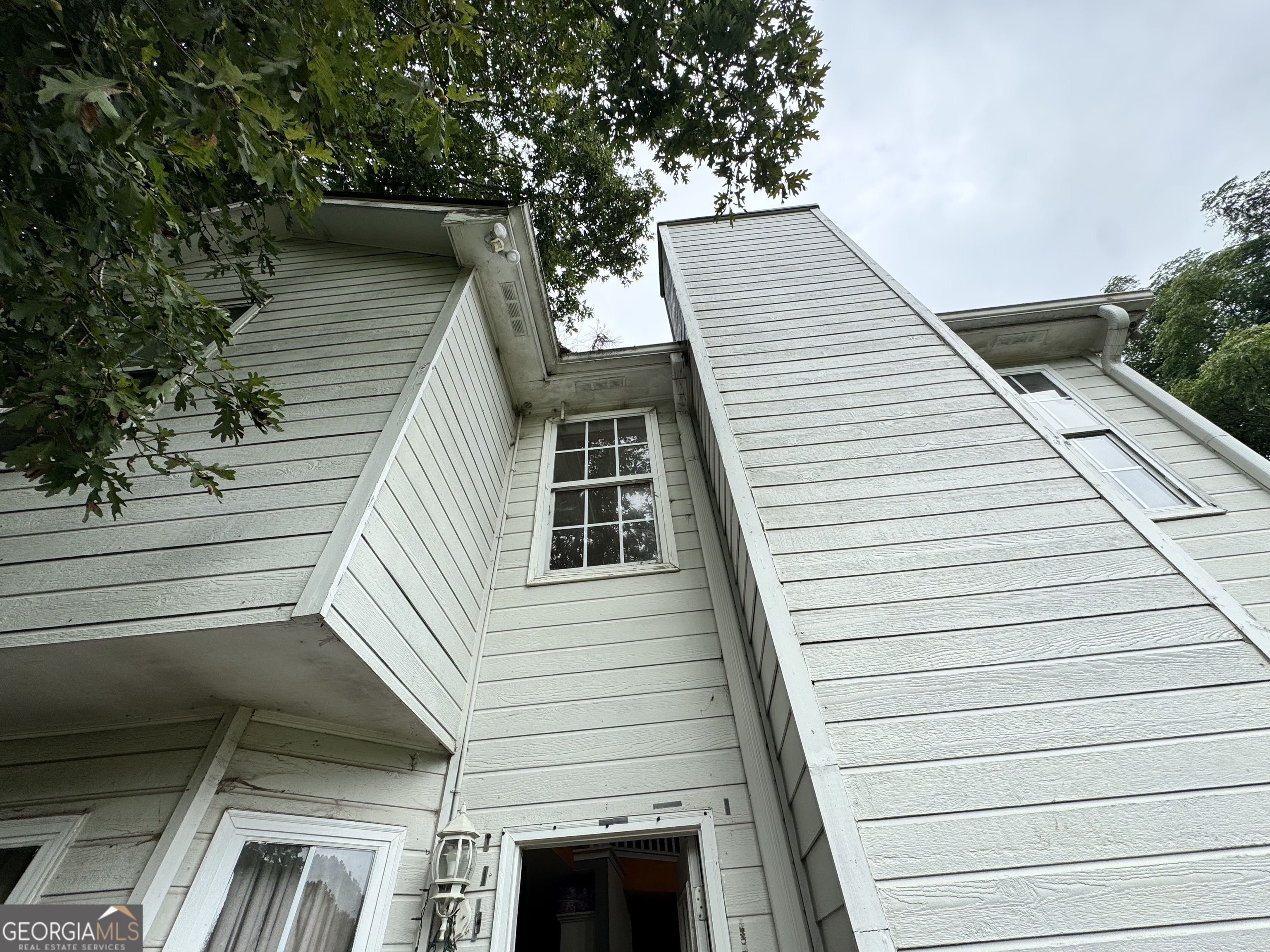 2487 Courtney Renea Drive Dacula, GA 30019 - Photo 16 of 16 a view of a balcony with wooden floor and fence and a potted plant