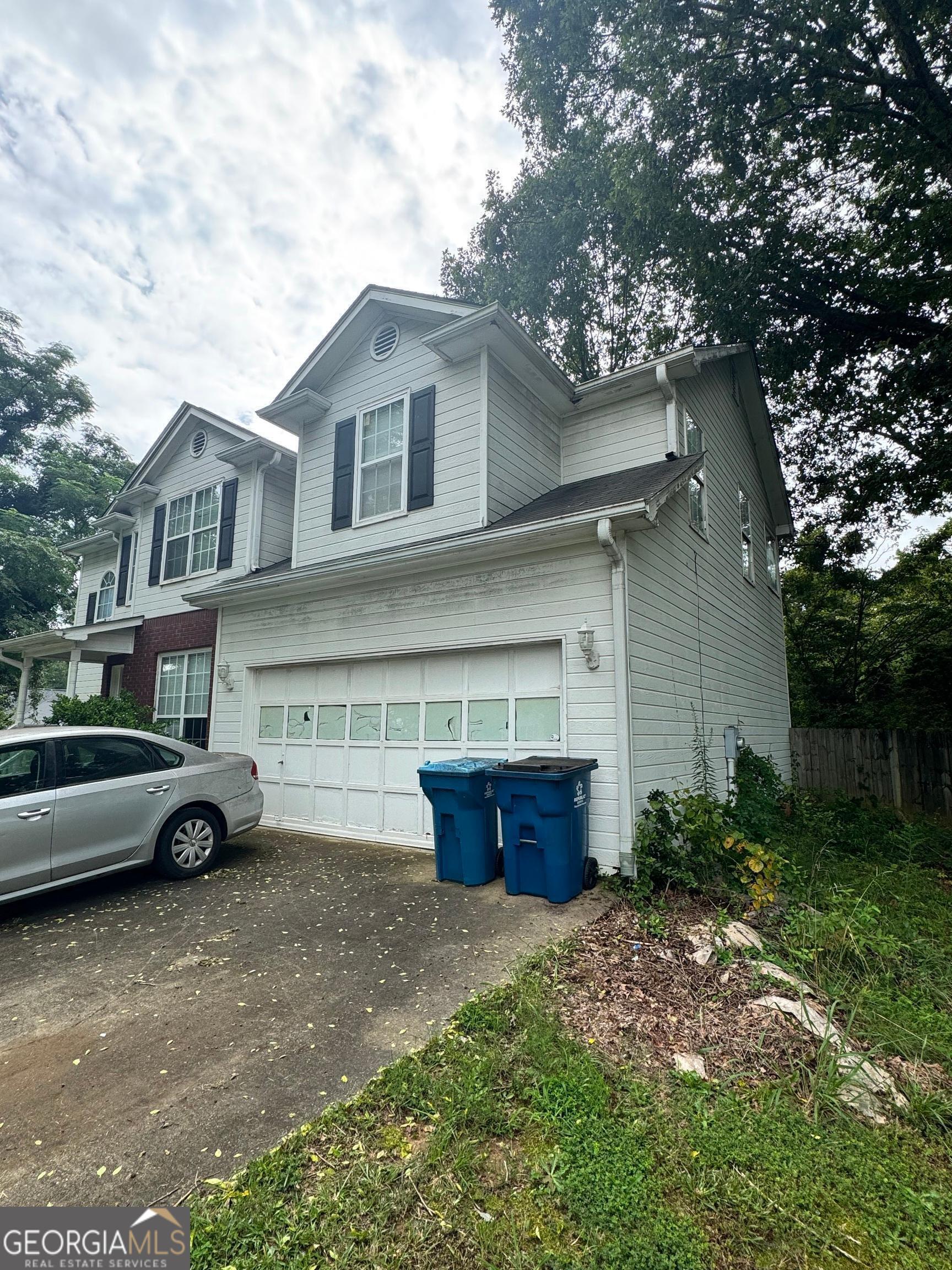 2487 Courtney Renea Drive Dacula, GA 30019 - Photo 2 of 16 a car parked in front of white house