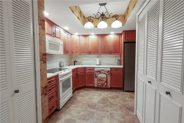 a kitchen with a stove a sink and cabinets