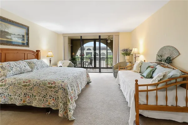 a spacious bedroom with a bed and a large window