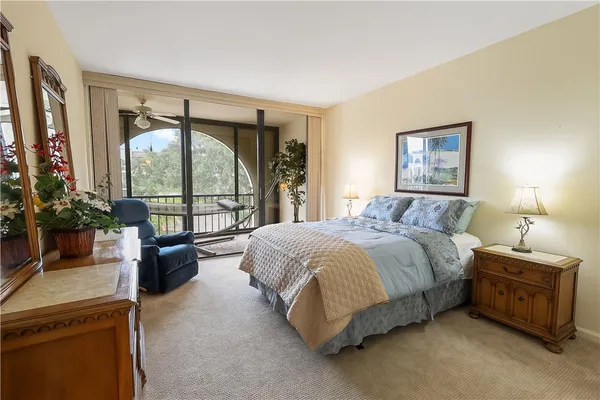 a bedroom with a bed and a balcony view