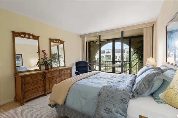 a bedroom with a large bed and a large window