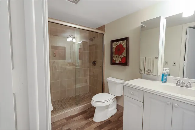 a bathroom with a sink toilet a mirror and shower