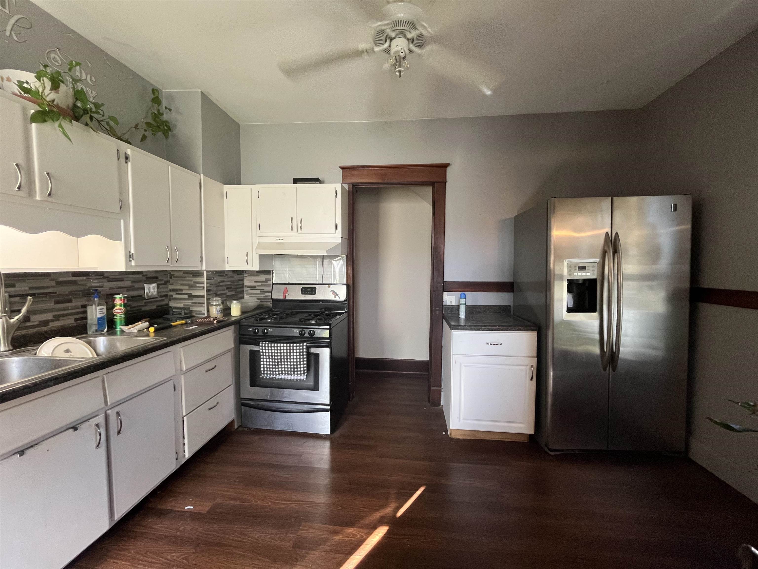 504 9th Street LaSalle, IL 61301 - Photo 3 of 16 a kitchen with stainless steel appliances white cabinets and wooden floor