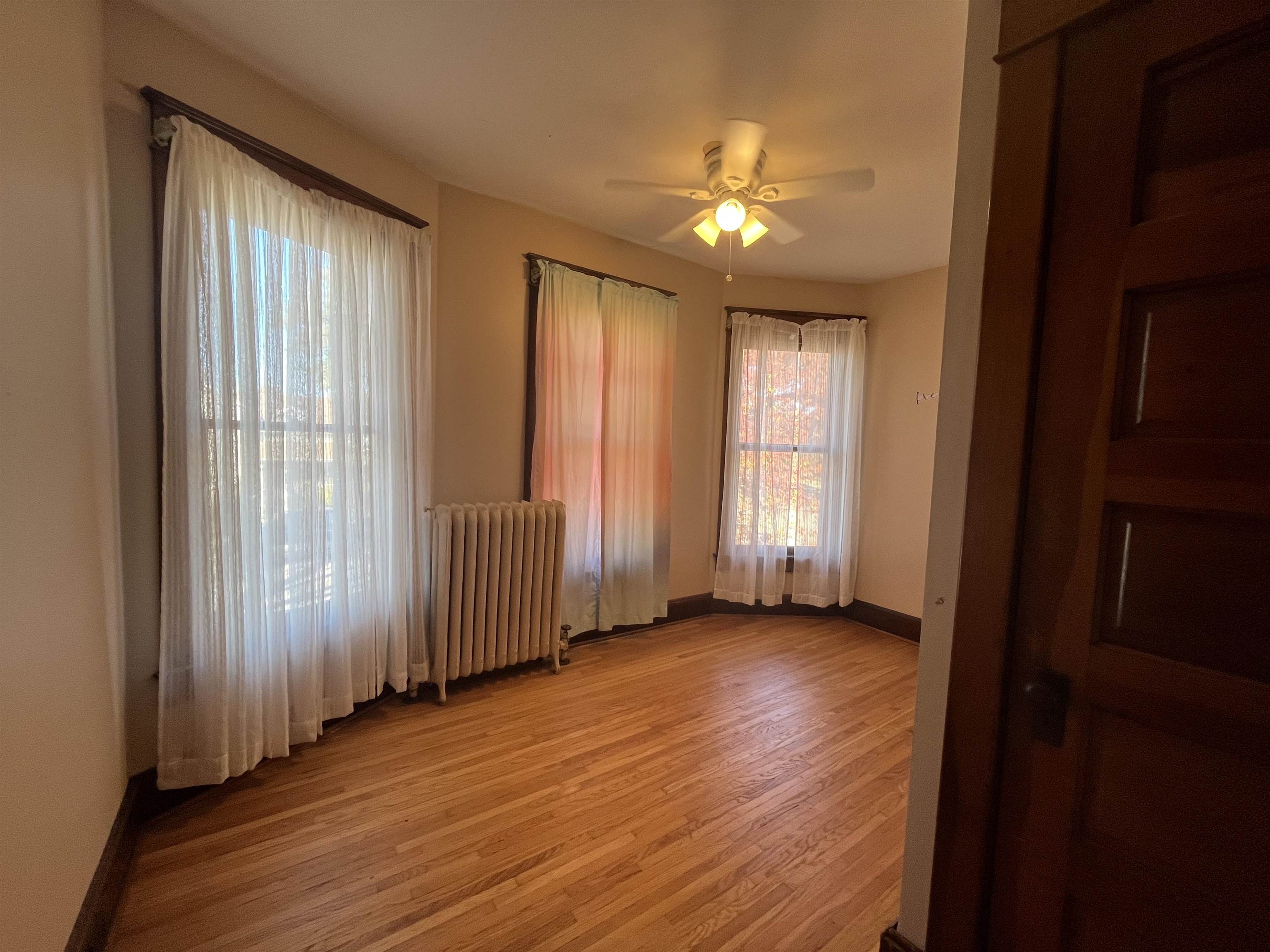 504 9th Street LaSalle, IL 61301 - Photo 4 of 16 an empty room with wooden floor and windows