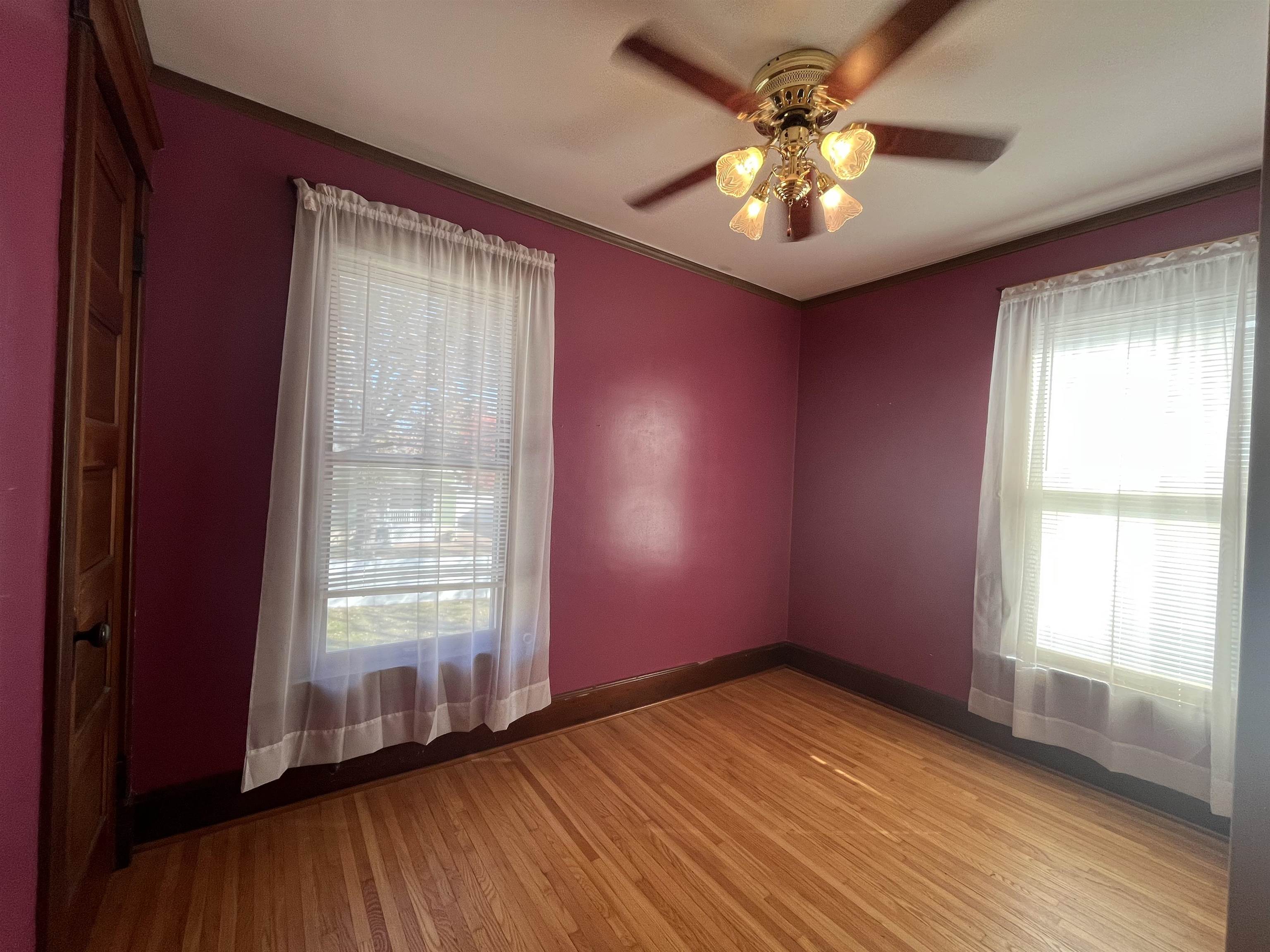 504 9th Street LaSalle, IL 61301 - Photo 7 of 16 an empty room with windows and chandelier fan