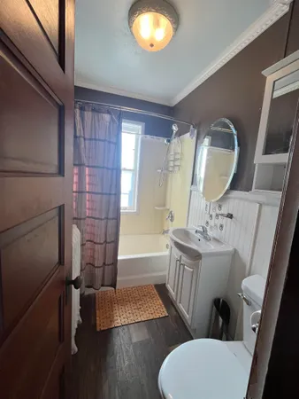 a bathroom with a toilet sink and mirror