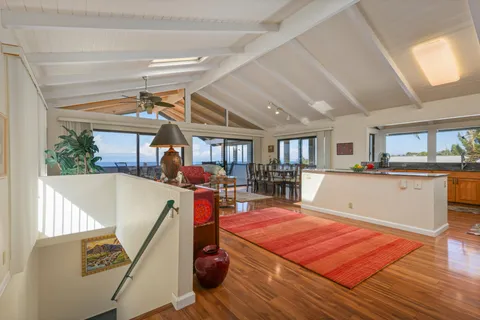 a bed room with a table gym equipment and a large window