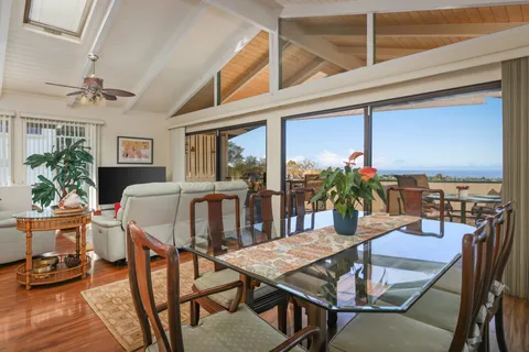 a living room with furniture a chandelier and a flat screen tv
