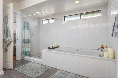 a bedroom with furniture and a window