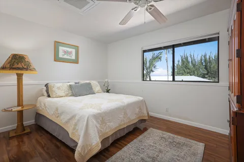 a bathroom with a granite countertop sink mirror vanity and toilet
