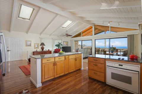 a room with pool table and large windows