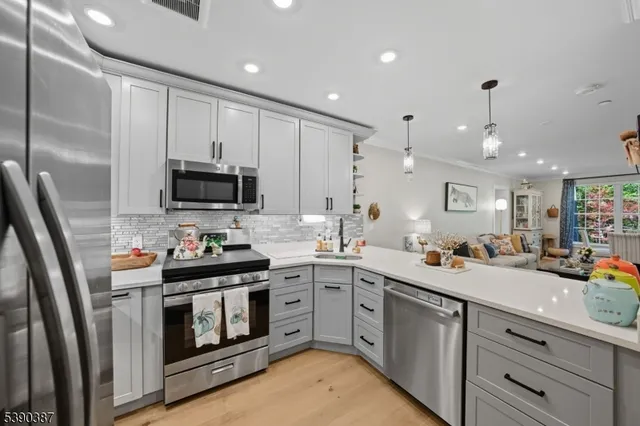 a kitchen with a sink stainless steel appliances and cabinets