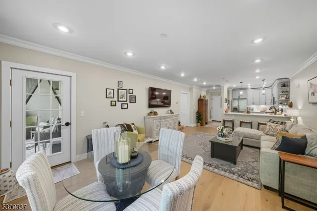 a living room with furniture and a view of kitchen
