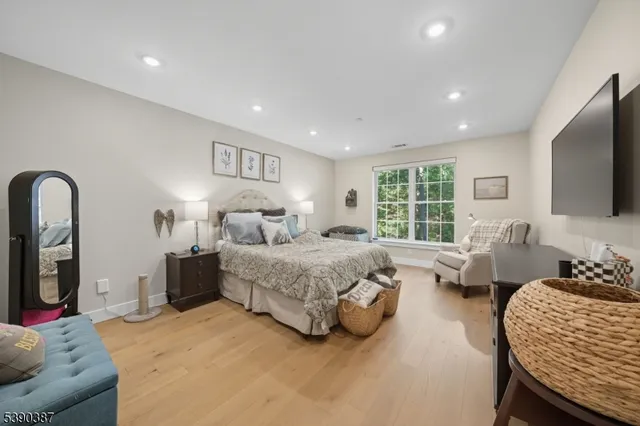 a spacious bedroom with a bed and glass windows