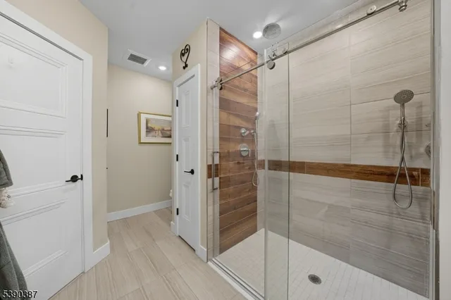 a bathroom with a shower and a glass door