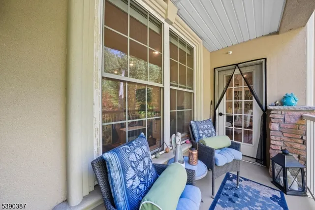 a living room with furniture a rug and a window