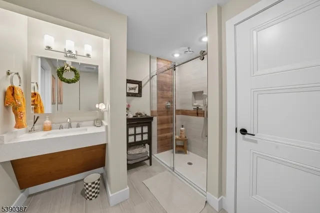 a bathroom with a shower sink and mirror