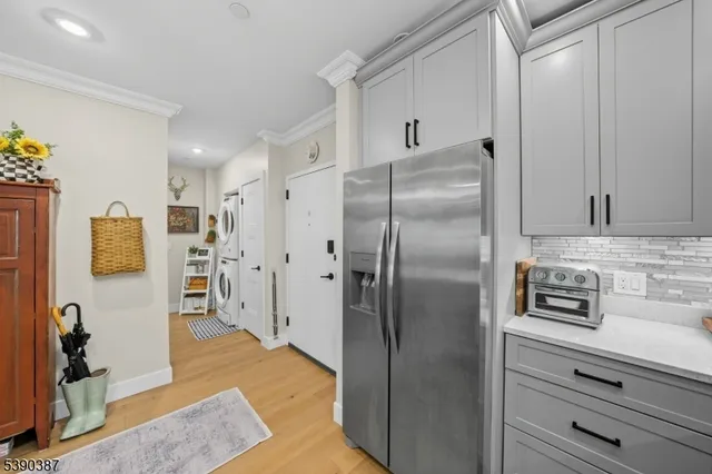 a kitchen with stainless steel appliances granite countertop a refrigerator and a sink