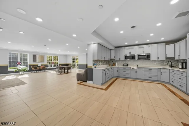 a room with pool table and windows