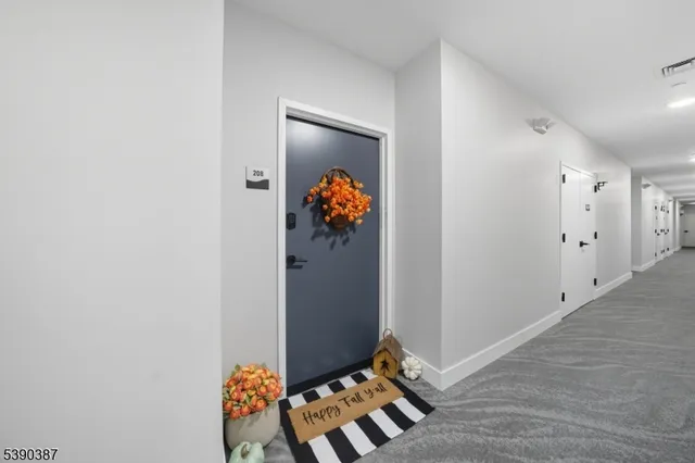 wooden floor with view of entryway