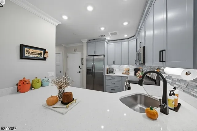 a kitchen with a sink and chandelier