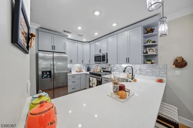 a kitchen with refrigerator and cars parked