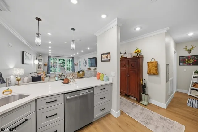 a kitchen with white cabinets and sink