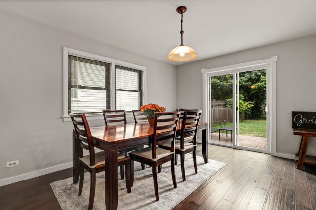 390 Bartram Road Riverside, IL 60546 - Photo 9 of 27 a view of a dining room with furniture wooden floor and chandelier