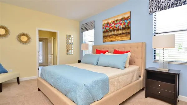 a bedroom with two beds and a large window